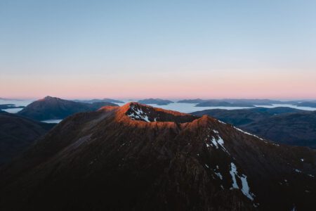 The Aonach Eagach ridge at first light, snow in its gullies.