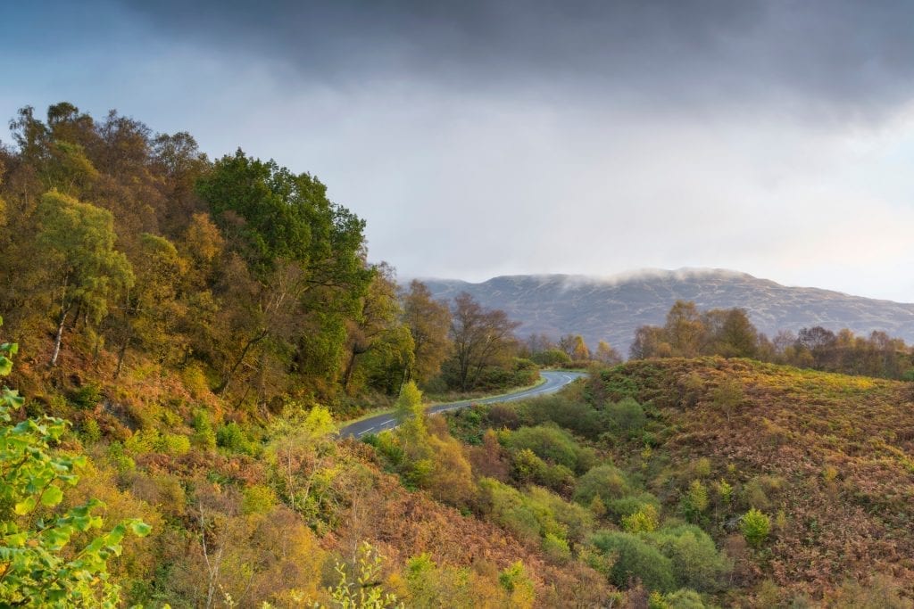 The Duke's Pass winding through autumn hills, the road curving away below.