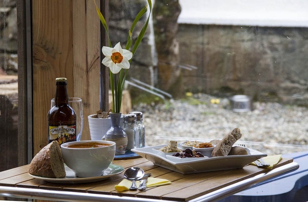 Soup, bread and a daffodil on a table by the window at the café at Calgary.