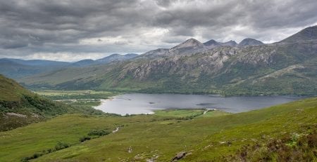 Loch Coruisk valley beneath the jagged Cuillin ridge under grey clouds