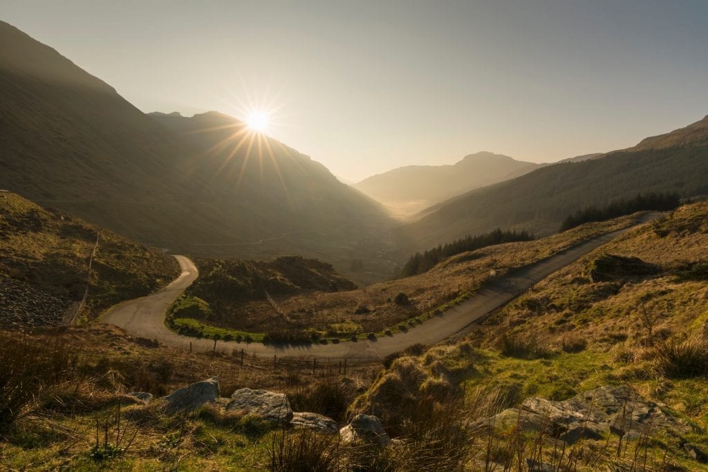 The road climbing Glen Croe to the Rest and Be Thankful between steep green hills.
