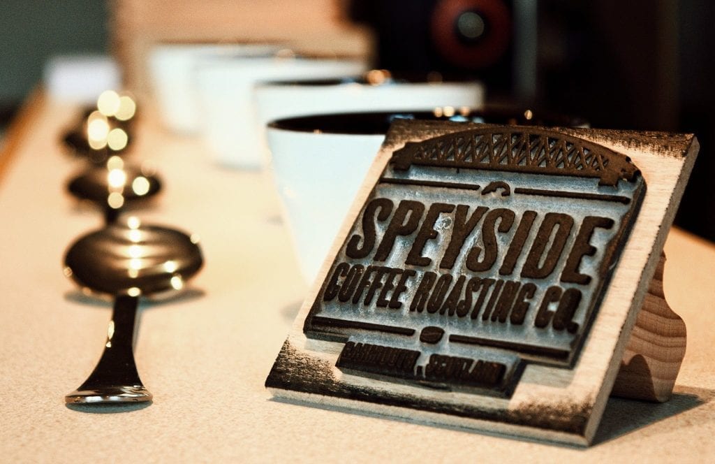 Speyside Coffee Roasting Co sign on a counter with white cups behind