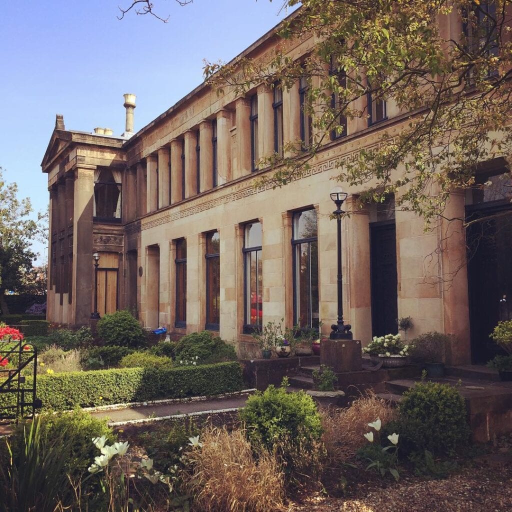 The length of Moray Place in low evening sun, its columns and pedimented end bay above the front gardens.