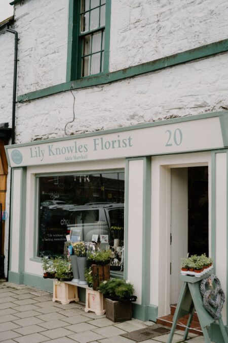 Green-trimmed shopfront of Lily Knowles Florist at number 20