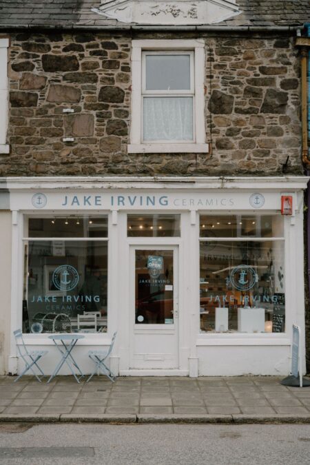 Jake Irving Ceramics shopfront with stone facade and small blue table outside
