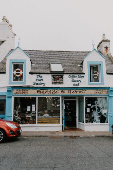 Blue-trimmed shopfront reading "The Port Pantry, Coffee Shop, Eatery, Deli" with lifebuoys in the windows