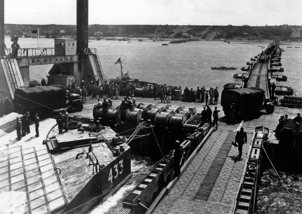 Landing craft 433 unloads vehicles onto a Mulberry harbour pontoon causeway