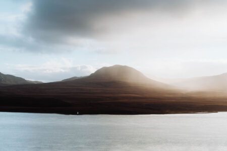 The Paps of Jura over moorland and water.