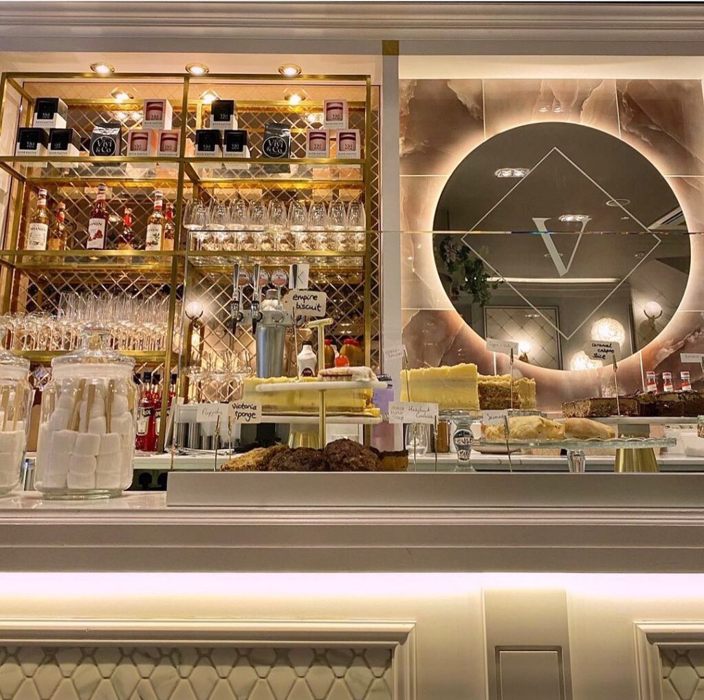 The bar with a mirrored back and a round logo on the wall.