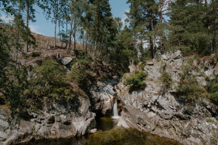 Waterfall tumbling through a rocky gorge into a pool below
