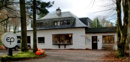 White stone building with slate roof, Forest Foto sign, pumpkins by entrance