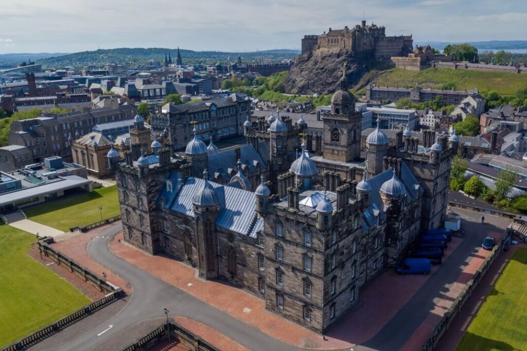 Turreted George Heriot's School with Edinburgh Castle on the hill beyond