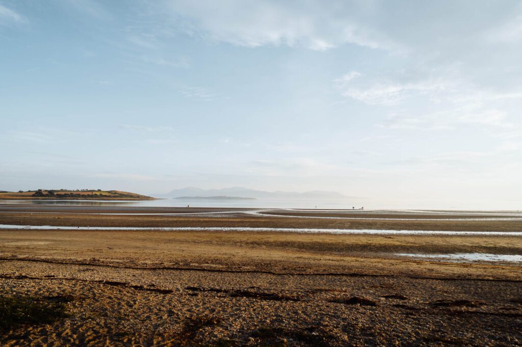 The wide sands of Ettrick Bay at low tide.