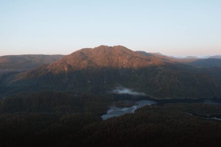 Ben Venue in low evening light above the forest and Loch Katrine.