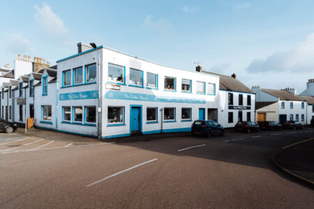 The long white building of the Celtic House on the corner, its windows along two streets.