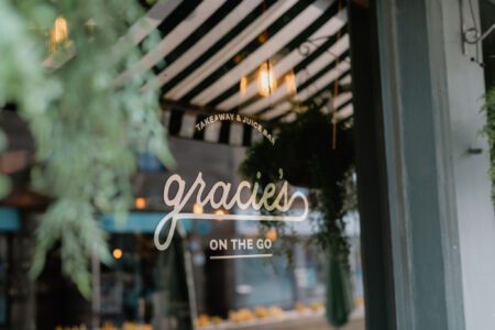 Gracie's On The Go window sign, takeaway and juice bar, striped awning above