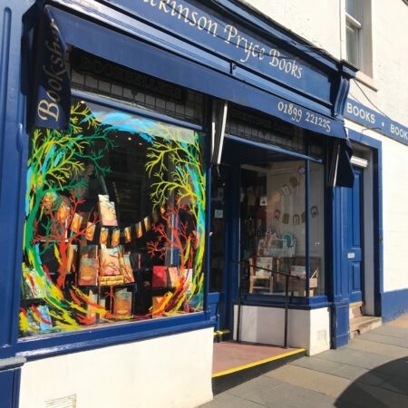 Dickinson Pryce Books shopfront, with a painted window and blue frontage