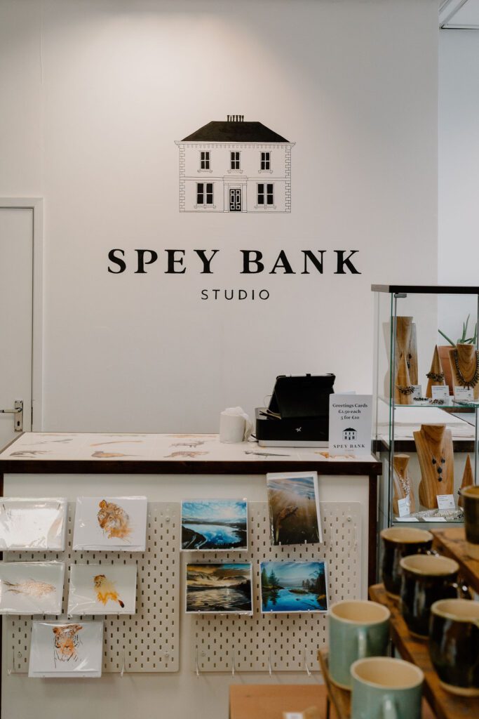Spey Bank Studio counter with greetings cards, prints and handmade mugs on display