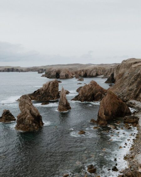 Jagged sea stacks rise from the water at Mangersta cliffs, Isle of Lewis