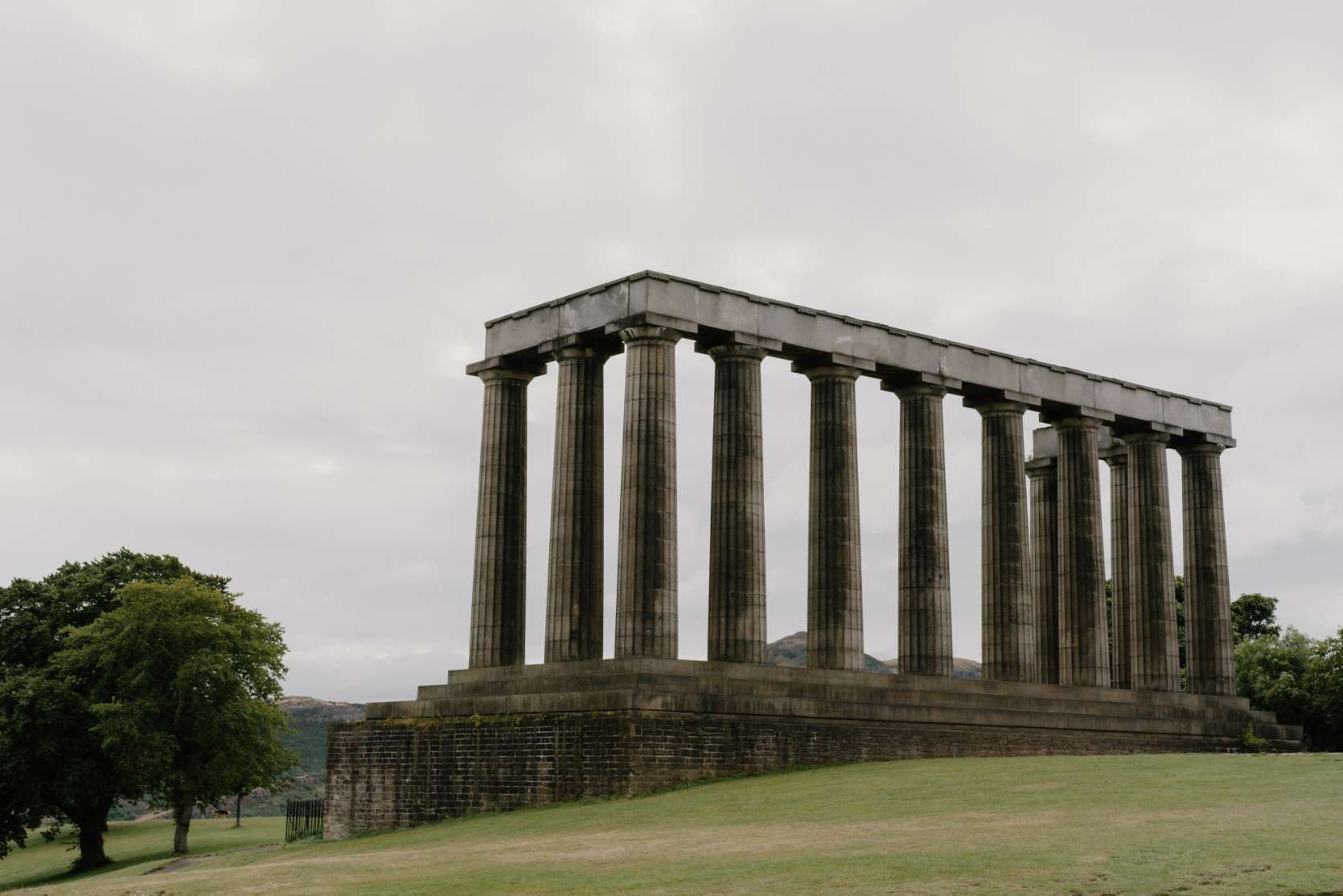 Rows of stone columns on Calton Hill under a grey sky