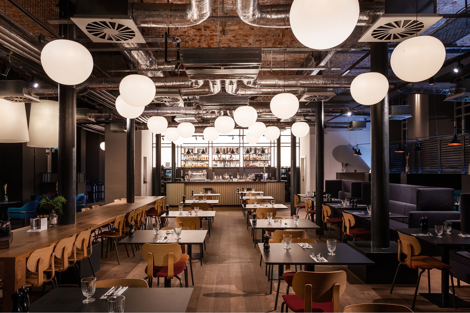 The restaurant at Daisy Tasker under the mill's columns and globe lights.
