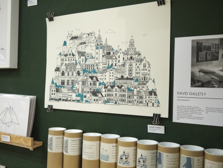 A framed drawing of Stirling above tins of biscuits.