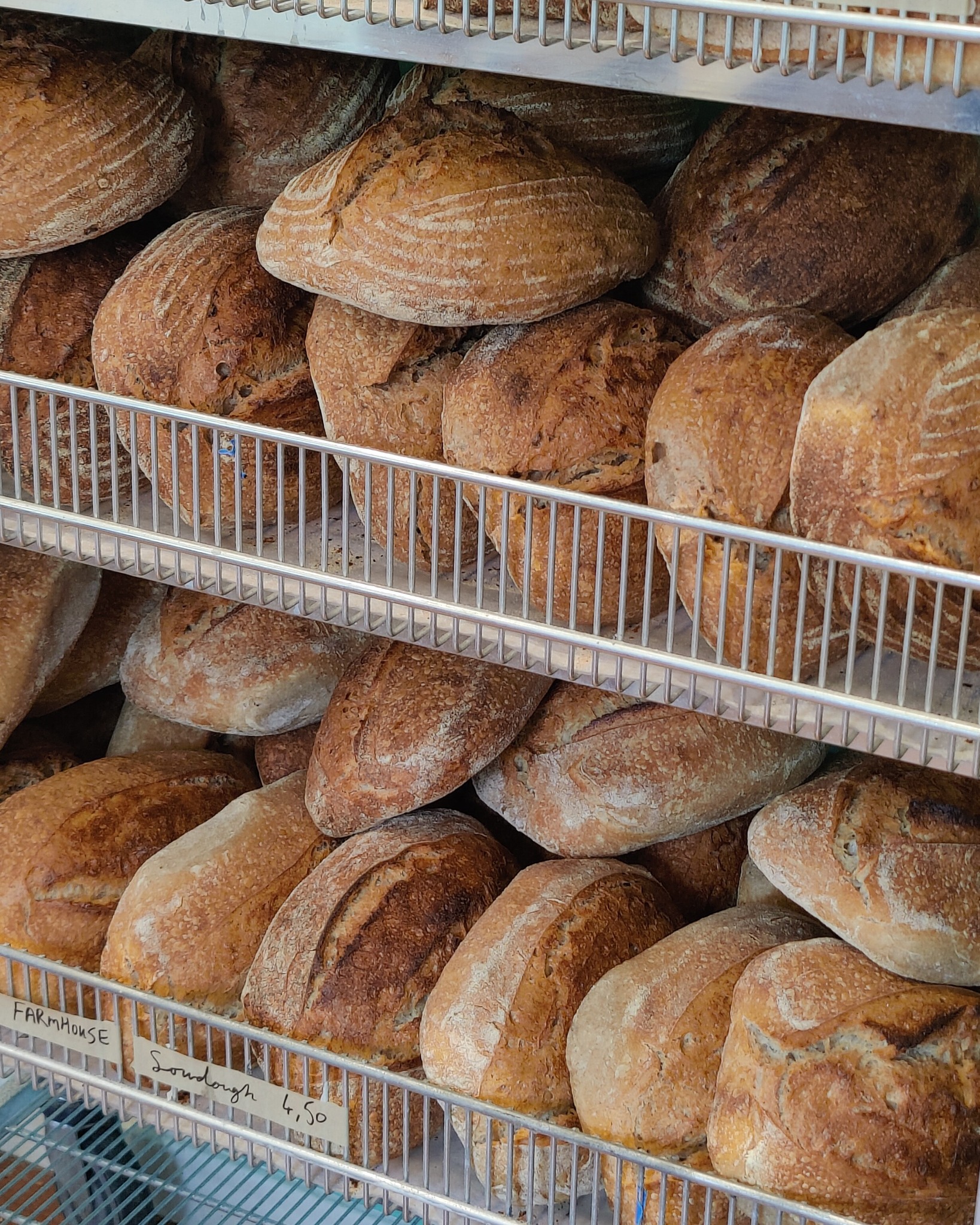 Shelves of floury sourdough loaves at Courie Courie.