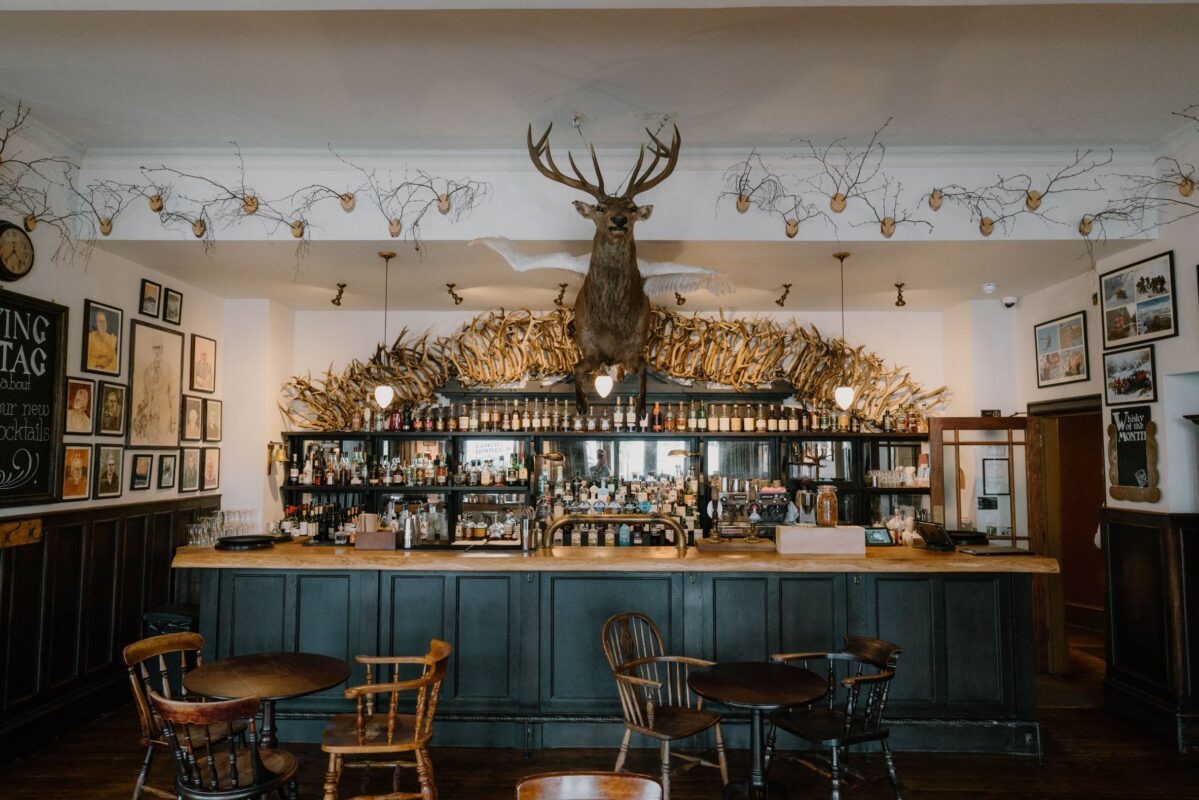 The Flying Stag's bar under a mounted stag and a crown of antlers.